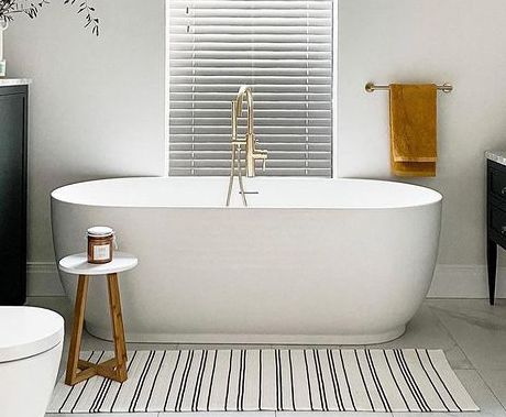 freestanding bath with brushed brass tap
