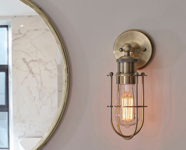 industrial style cased wall light in antique brass