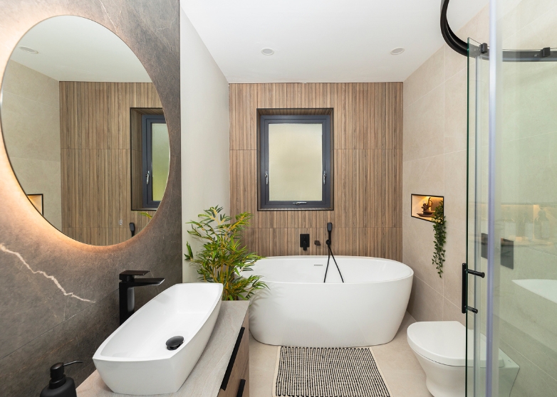 Modern bathroom with freestanding bathtub with matt black taps and wood effect finish tiles